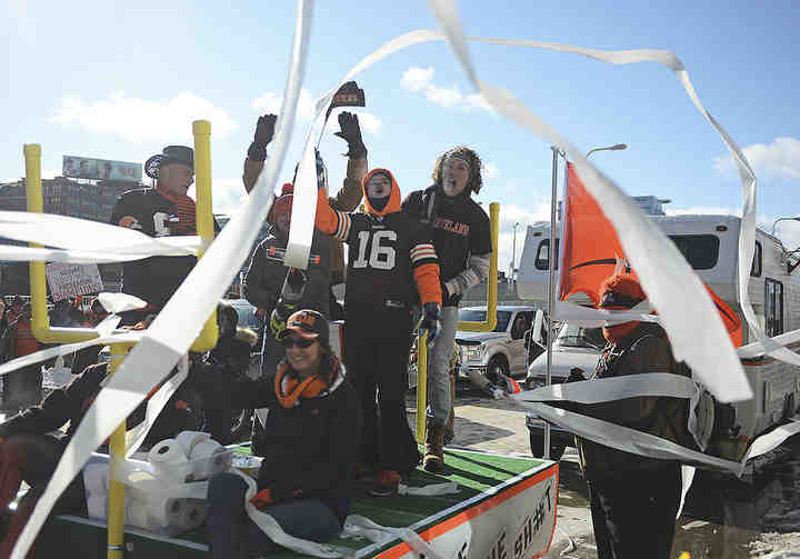 Fans riding on a float shoot toilet paper toward FirstEnergy Stadium at the Browns Perfect Season Parade in Cleveland. The Browns finished the season with a record of 0-16.  (Leah Klafczynski / Akron Beacon Journal)